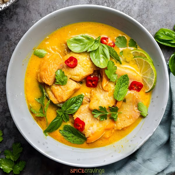 Masthi Indian Cuisine's chicken curry with basil, mint, chili, and lime in a white bowl.
